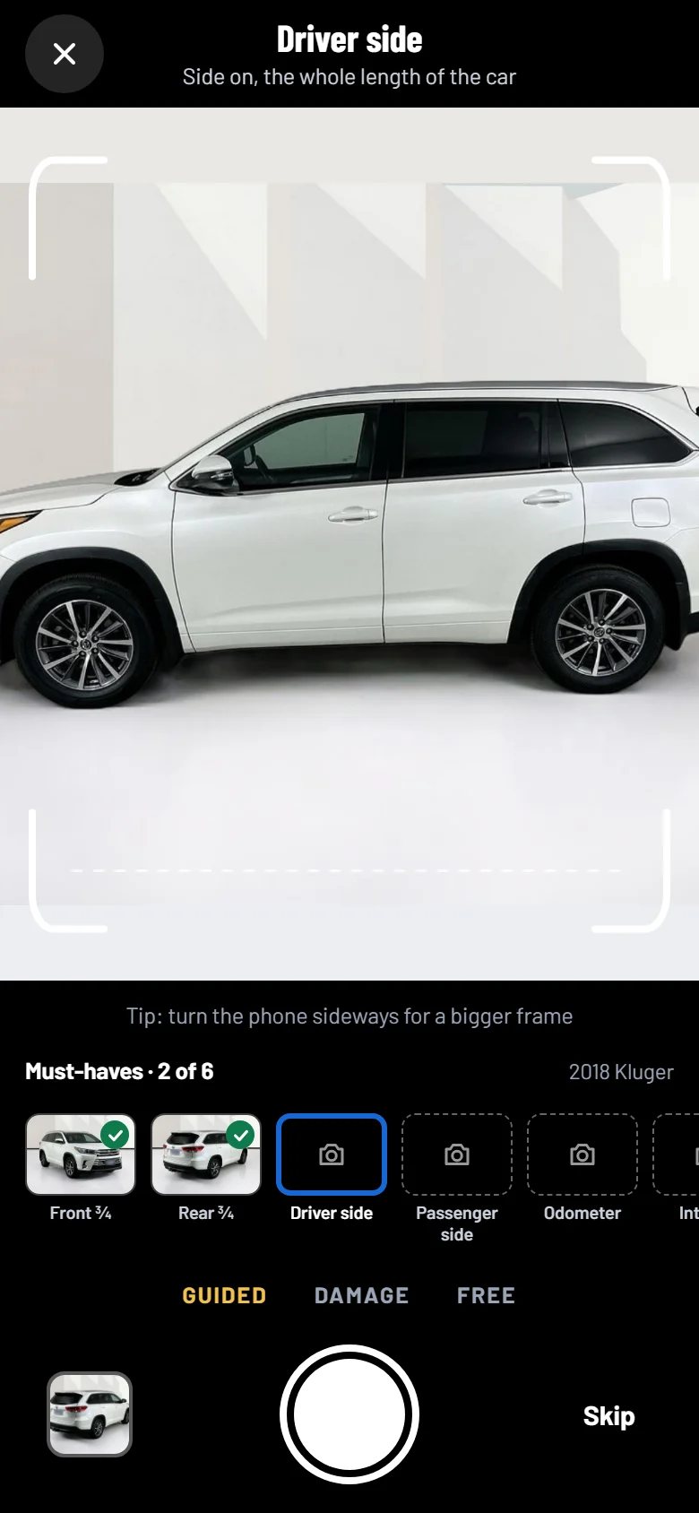 The guided camera on a phone, framing the driver side of a 2018 Toyota Kluger